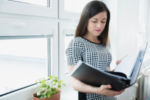 woman-with-big-folder-posing-office_23-2147656656